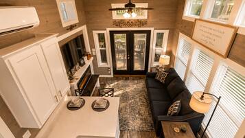 A compact living space with a kitchenette, dining area, and seating area.