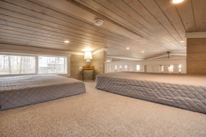 A room with two beds, a lamp, and a window. - Edgewater at The Retreat at Water's Edge (Tracy City)