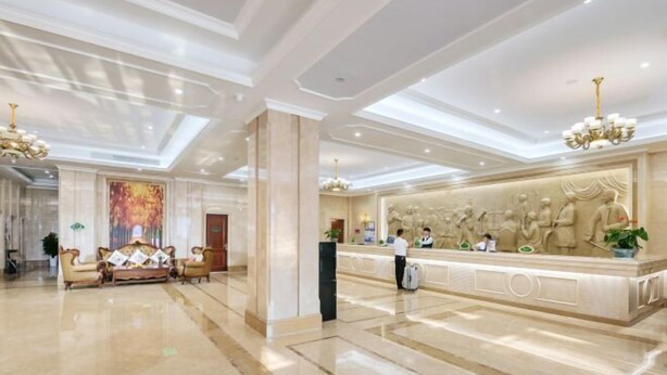 A spacious lobby with a reception desk, seating area, and a large mural. - Vienna International Hotel (Wenzhou Rui'an Tangxia) (Rui'an)