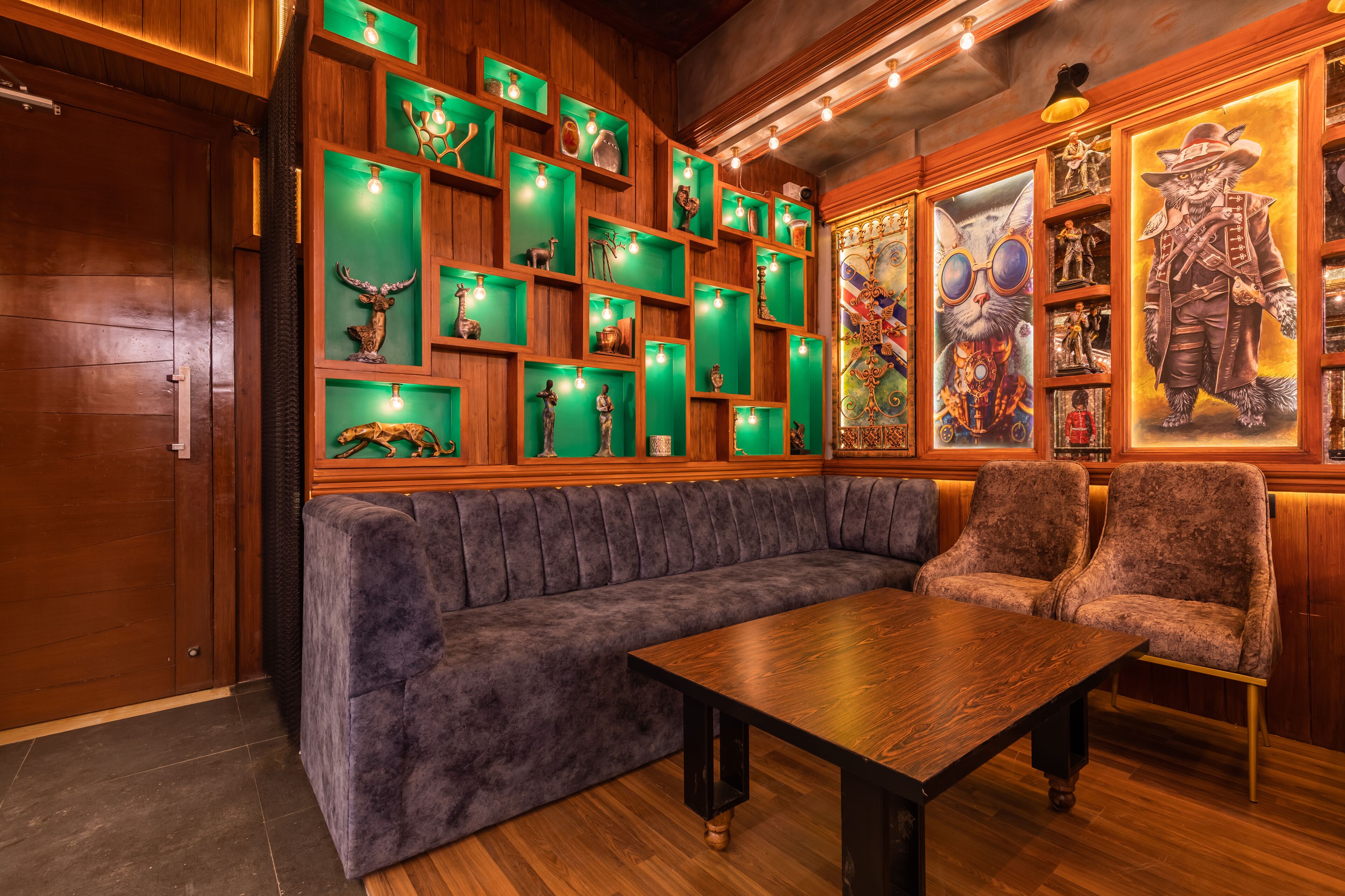 A cozy room with a wooden bench, a table, and shelves with various decorative items.
