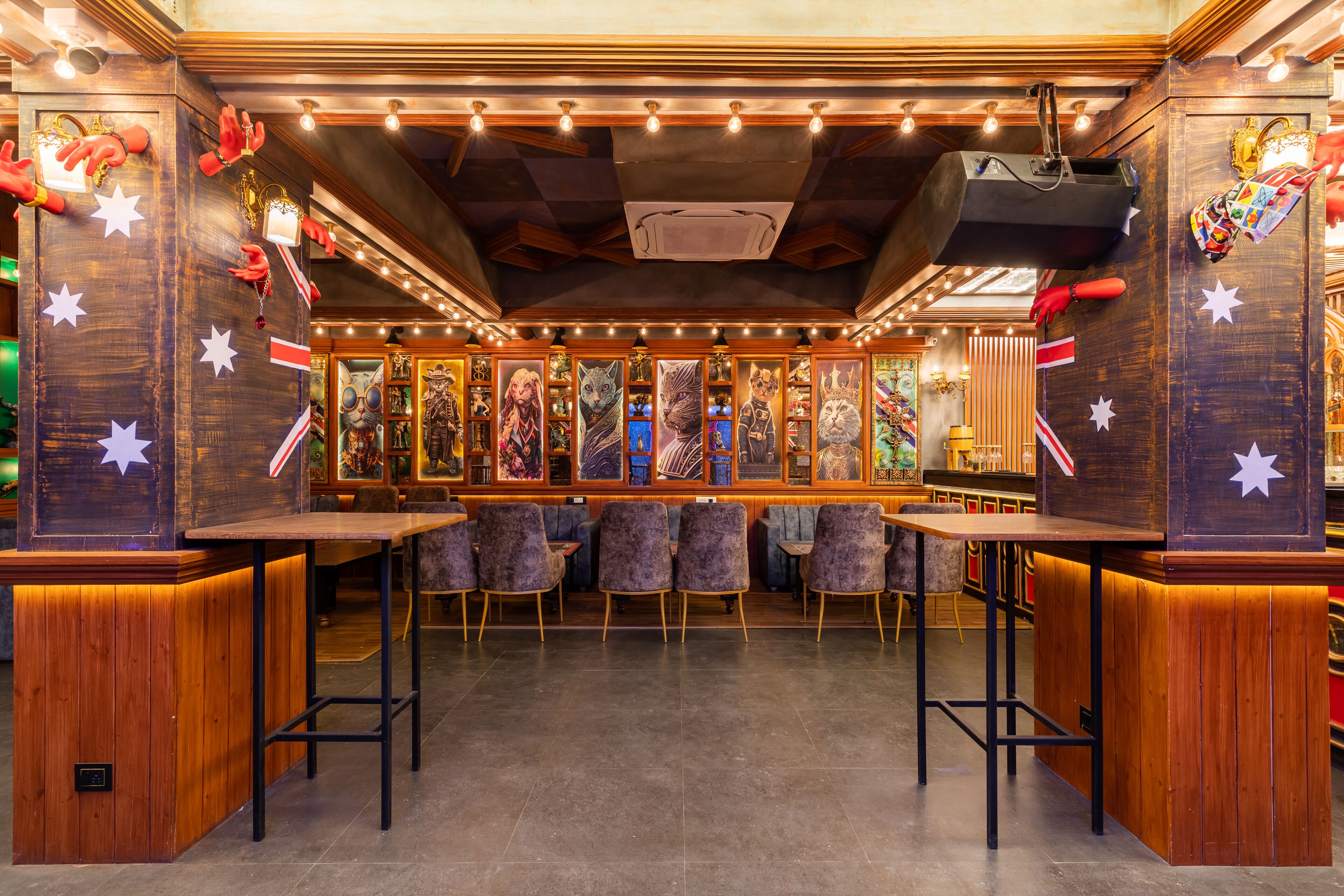 A bar area with wooden paneling, star decorations, and a variety of framed artworks on the walls.