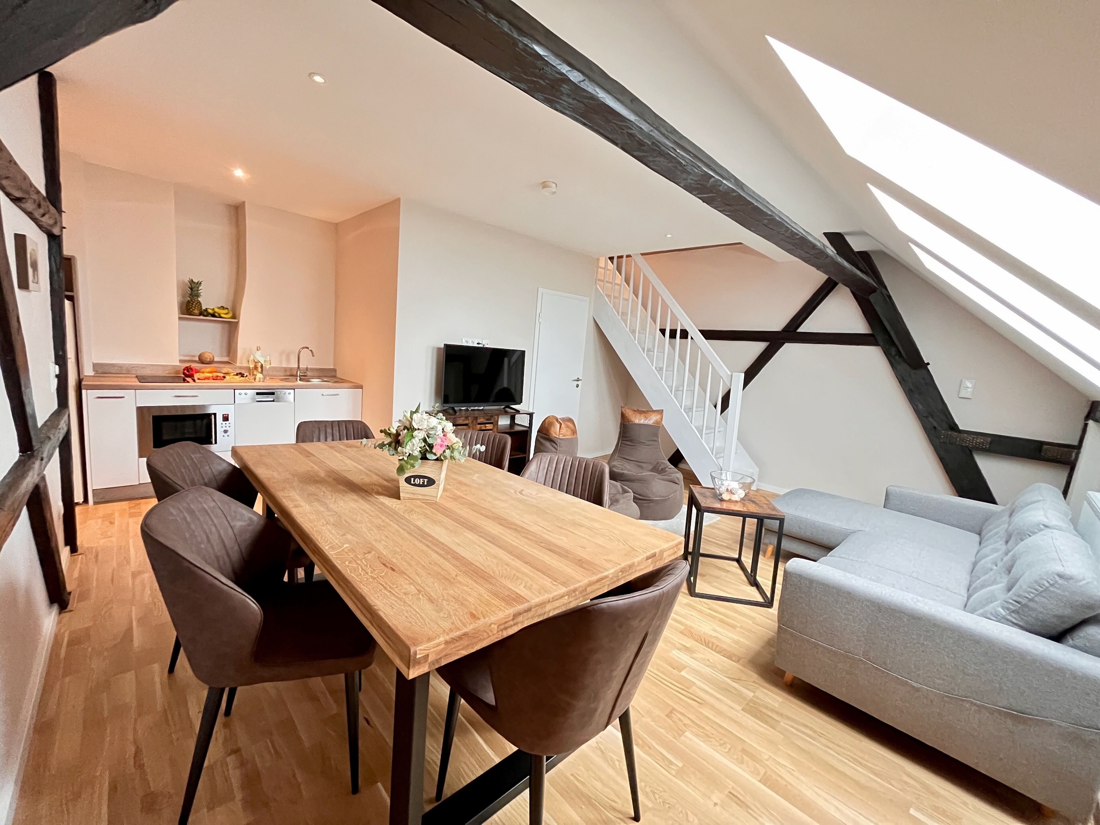 Un loft moderno con comedor, cocina y sala de estar.
