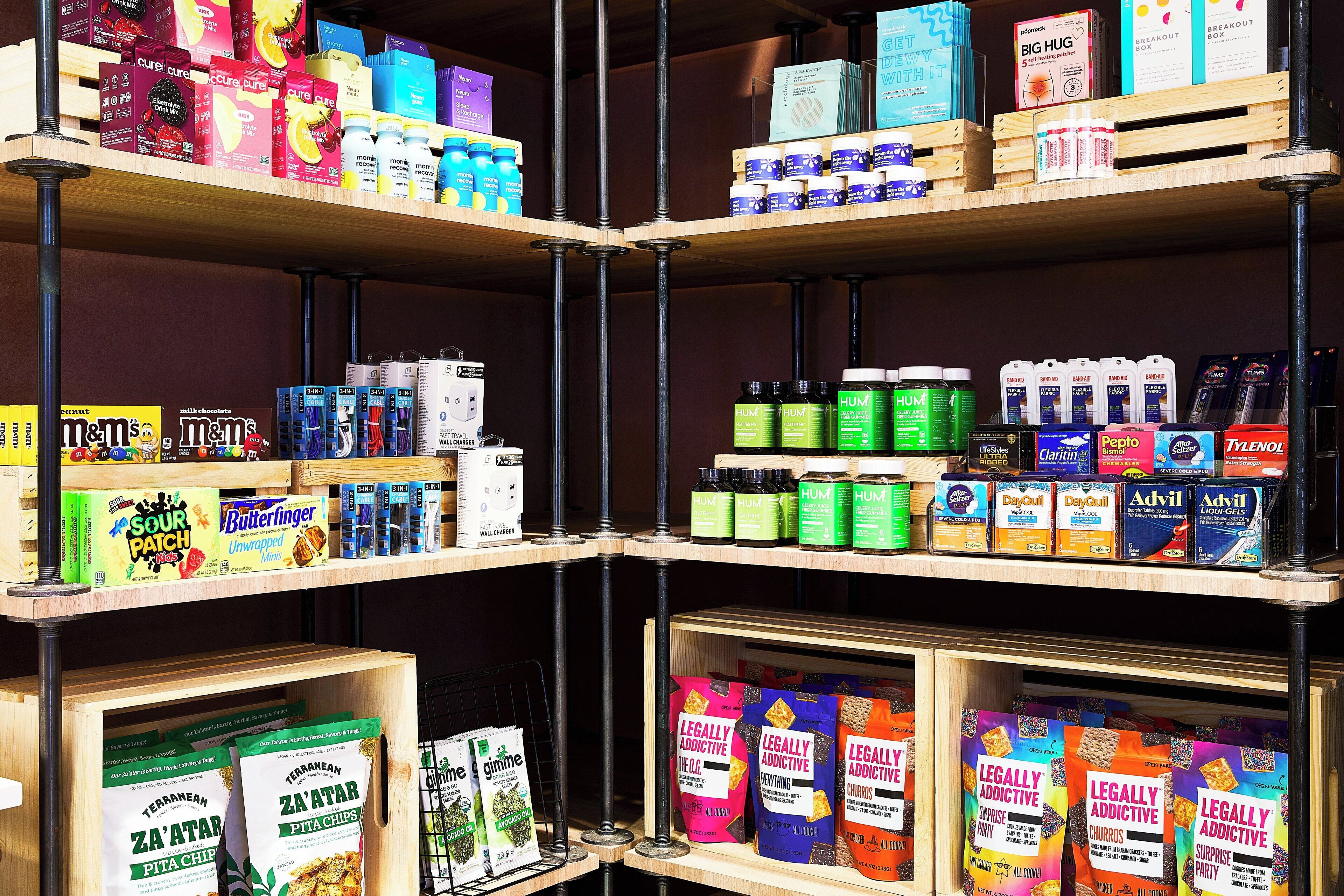 Shelves stocked with various products including snacks, beverages, and health supplements.
