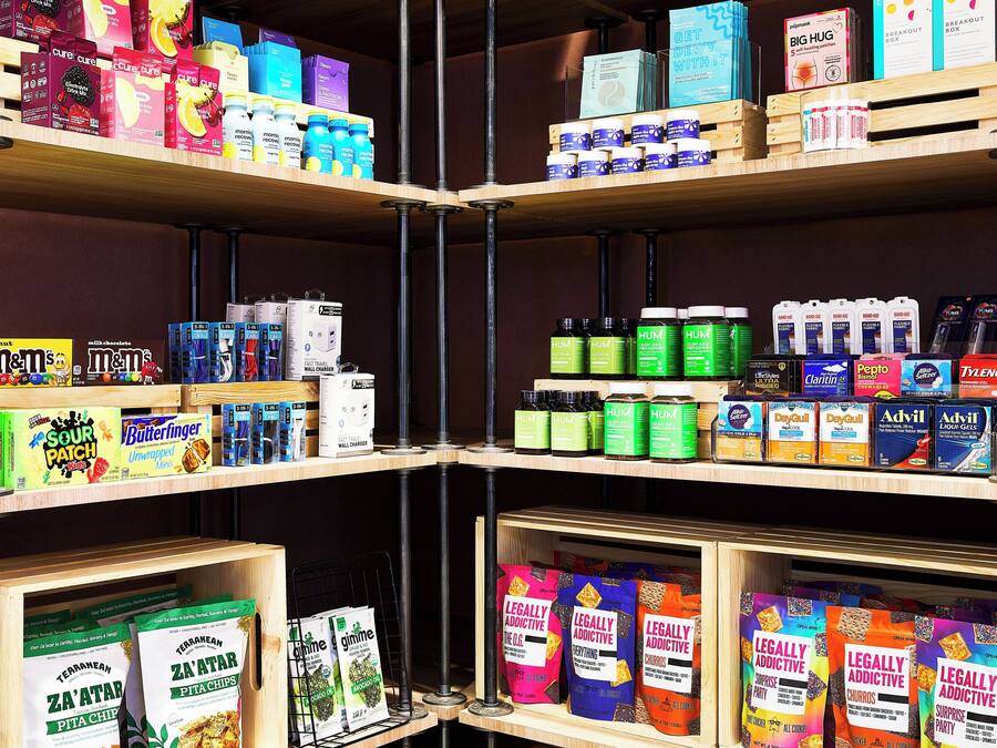 Shelves stocked with various products including snacks, beverages, and health supplements.