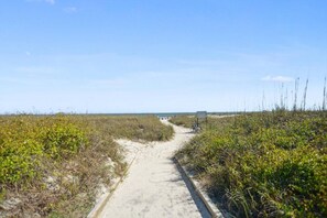 A sandy path leading through a natural landscape with sparse vegetation. - Oceanfront Sunrises in Upgraded Seaside Villa 225 (Hilton Head Island)