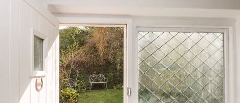 A white door with a glass window, a metal handle, and a keyhole.