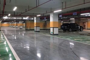 A multi-level parking garage with clear signage, a clean floor, and a vehicle parked in one of the bays. - Light Time Hotel (Nanning Greenland Central Plaza) (Nanning)