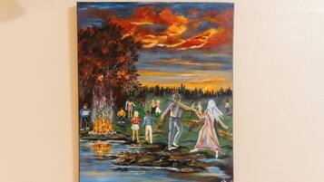 A painting of people by a river at sunset.