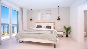A modern bedroom with a large bed, a view of the sea, and a balcony. - Beachfront Villa Draga with 32sqm private, heated pool, 4 bedrooms, sea view (Omis)