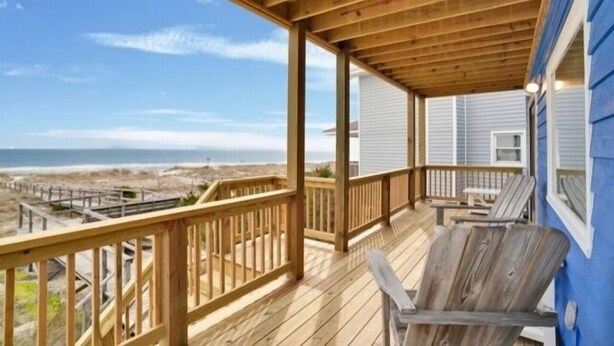 A wooden deck with a view of the beach and ocean. - Sea Haven - Oceanfront! Amazing Master Suite With A Private Oceanfront Deck! Recently Renovated And Perfect For The Entire Family 3 Bedroom Home by RedAwning (Kure Beach)
