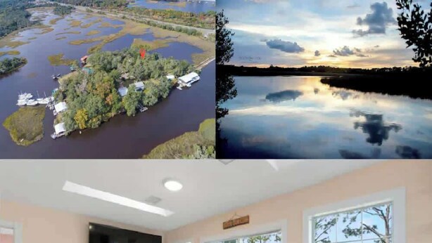 A modern interior with a sofa, TV, and large windows overlooking a natural landscape. - Waterfront Fishing Cottage, 2 King Beds, 75in HDTV, Family Friendly (Jacksonville)