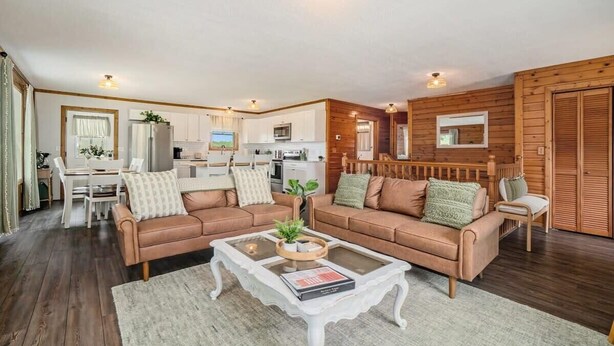 A cozy living room with two sofas, a coffee table, and a dining area. - Hot Tub! | Pet Friendly! | Game Room! (Traverse City)