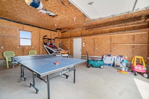 A ping pong table in a room with wooden walls, a window, and a door. - Hot Tub! | Pet Friendly! | Game Room! (Traverse City)