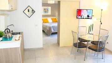 Design Suite, 1 Bedroom, City View | Living area | Flat-screen TV