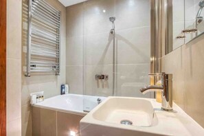 Ein modernes Badezimmer mit einer Badewanne, einer Dusche und einem Waschbecken.