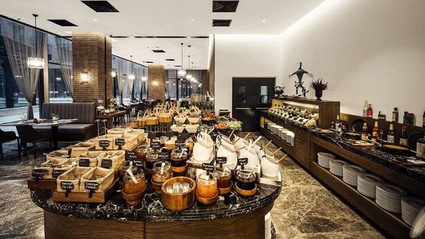 Montaje de buffet con diversos alimentos y salsas.