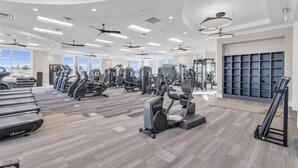 A spacious gym with treadmills, elliptical machines, and weight stations. - Babcock Ranch Golf Bundle Condo in Babcock National (Punta Gorda)