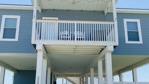 A two-story building with a covered porch and a visible garage door.