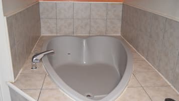 Room, 1 King Bed, Non Smoking, Jetted Tub | Bathroom | Combined shower/tub, rainfall showerhead, towels, soap