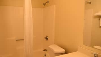 A bathroom with a bathtub, toilet, and sink.