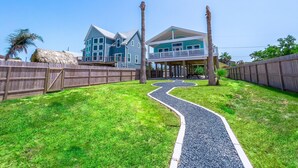 A two-story house with a porch and a pathway leading to it. - Waterfront Bay Views | Beautiful Private Pier (San Leon)