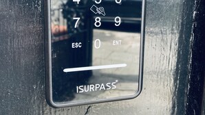 A glass door with a numeric keypad and an "ESC" button, labeled "ISURPASS". - Abbeyfield Guesthouse (Liverpool)