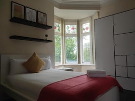 Premium bedding, desk, laptop workspace, soundproofing