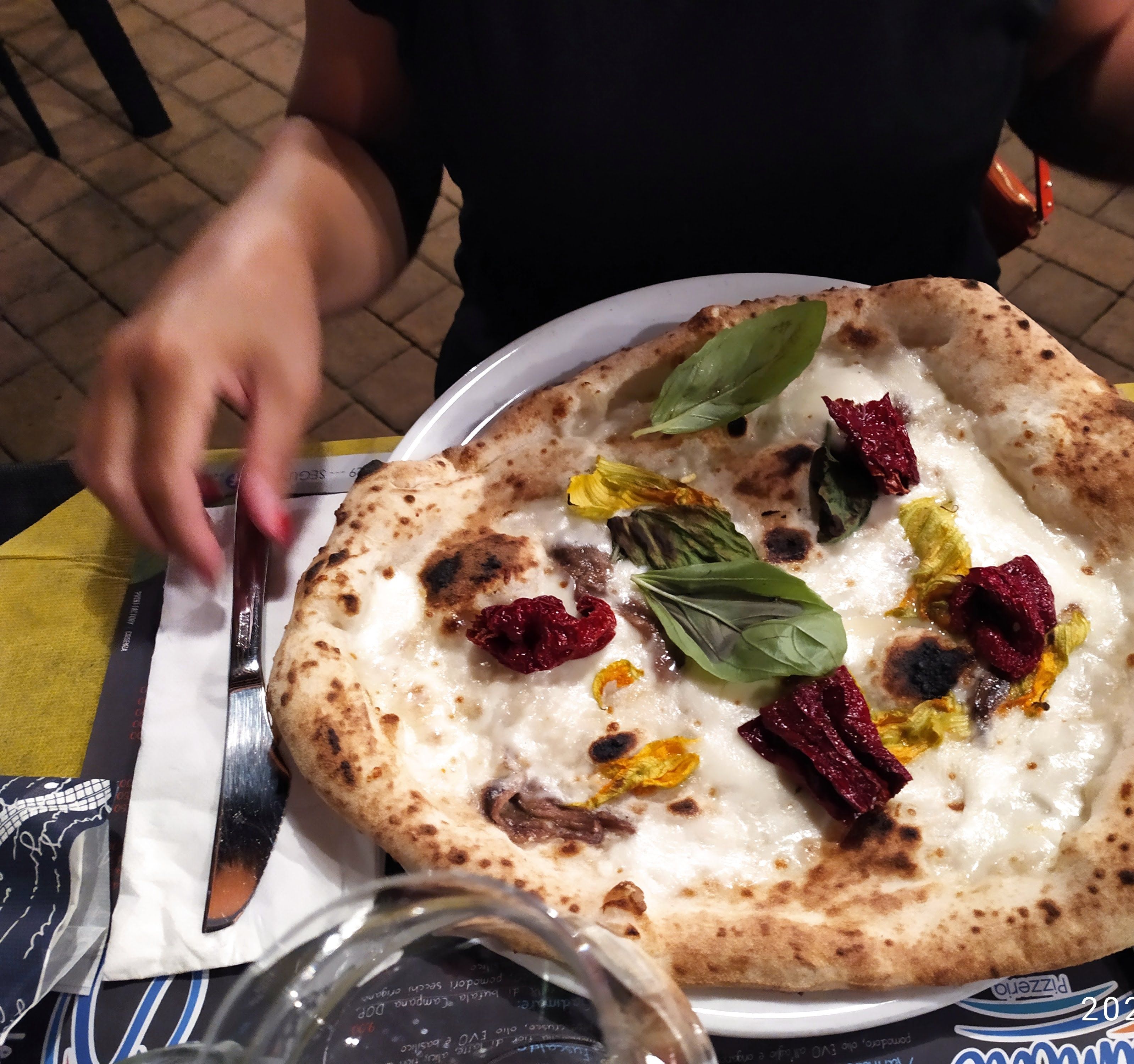 A pizza with toppings on a plate.