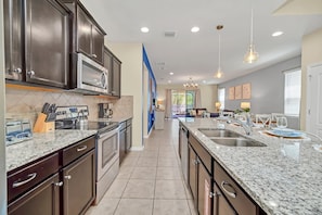 Enjoy cooking in this well-equipped kitchen with a double sink, oven, and dishwasher.