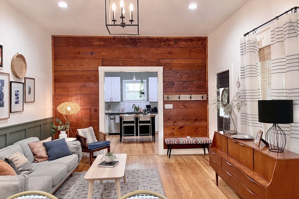 Living Room with original shiplap wall and original floors.