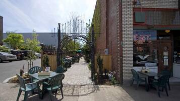Relax in a casual outdoor setting with comfortable seating and a charming entrance.