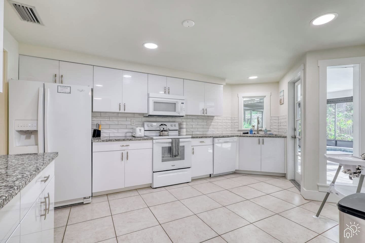 A modern kitchen with white cabinetry, a microwave, oven, and a dishwasher.