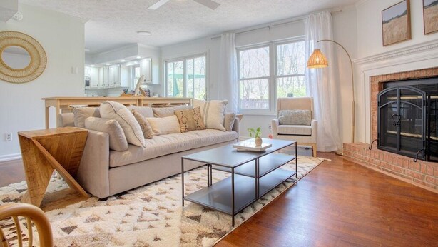 A living room with a sofa, coffee table, and fireplace. - The Retreat - Private Pool-Spa-Firepit-Gameroom (Greenwood)