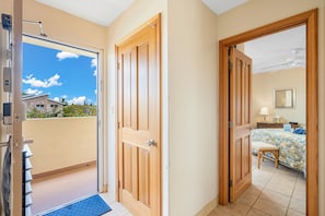Step out onto the balcony from this inviting room, featuring a comfortable bed and stylish decor.