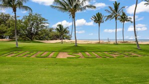 A well-manicured golf course with a clear path marked by the words "MALIBU SUNSET." - Maui Sunset A303 - Great large 1 bedroom close to ocean (Kihei)