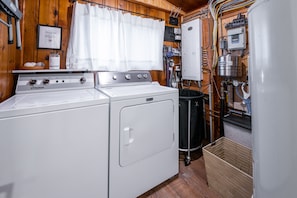 A compact kitchen with a stove, oven, and washing machine.