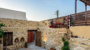 A stone-walled courtyard with a wooden gate, potted plants, and a sign reading "Villa Den View." - Sunset Villa - Panorama Sea View Villa (Platanias)