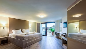 A modern hotel room with a large bed, a desk, and a balcony with a potted plant. - Sunset Villa - Panorama Sea View Villa (Platanias)