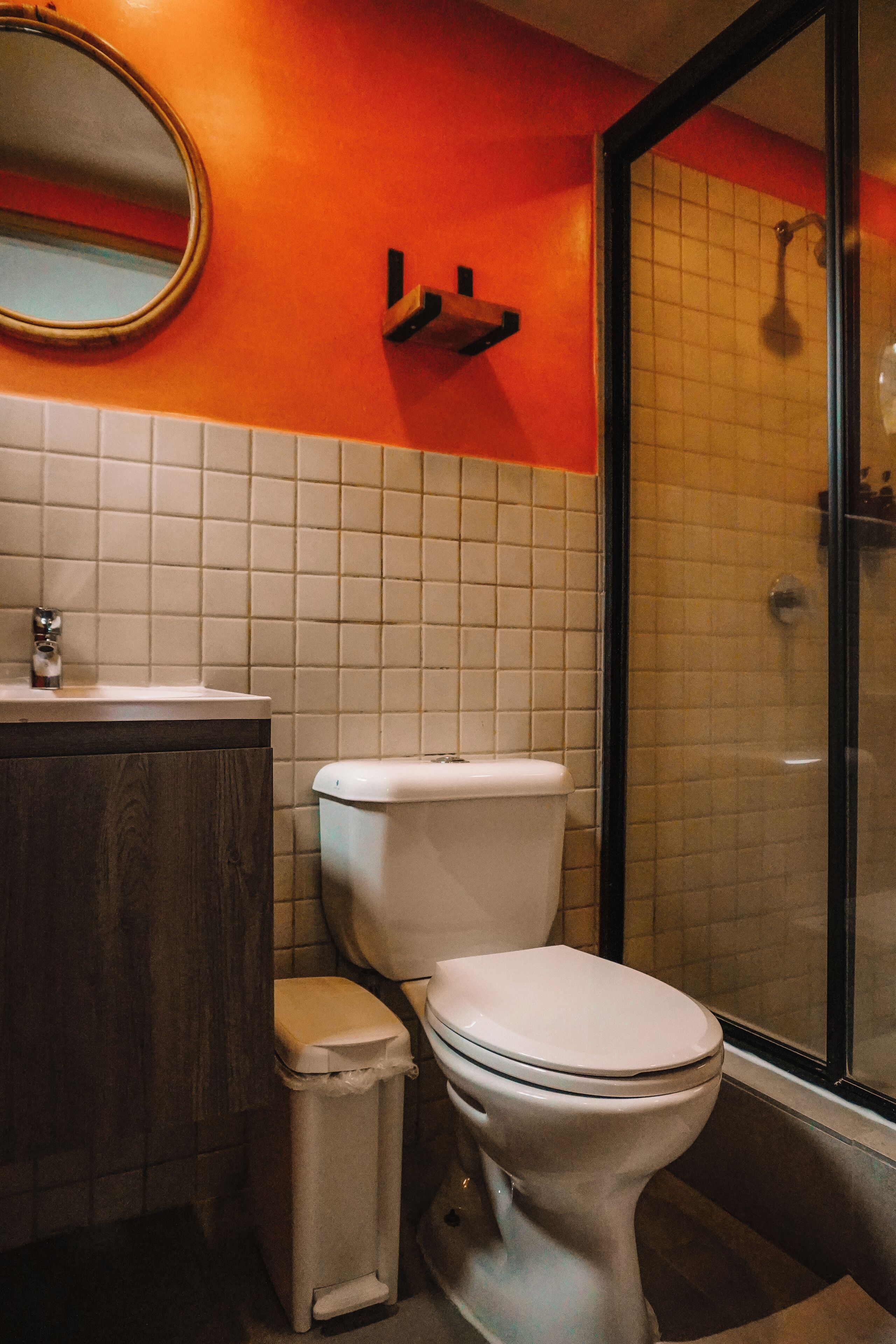 A bathroom with a toilet, sink, and shower area.