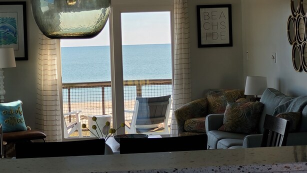 A living room with a view of the beach, a sofa, a chair, and a table with decorative items. - BEACHFRONT
Gorgeous View!!!
OCEANFRONT
Sunday to Sunday (Eastpoint)