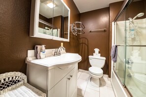 A bathroom with a white sink, a mirror, a toilet, and a glass-enclosed shower. - Ski In Ski Out Stagecoach Lift at Heavenly 3BR 3BA (Stateline)
