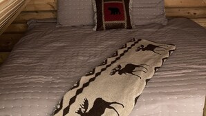 A cozy attic bedroom with a bed, pillows, and a blanket. - Cozy Quiet Alaskan Cabin (Soldotna)