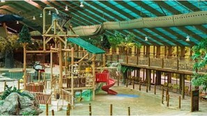 Explore a fun play area with a spiral slide, climbing frame, and seating areas.