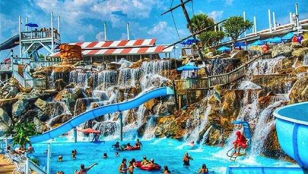 A water park with multiple slides and a pool area.