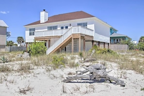 Enjoy the ocean views from the covered porch of this beachfront house.