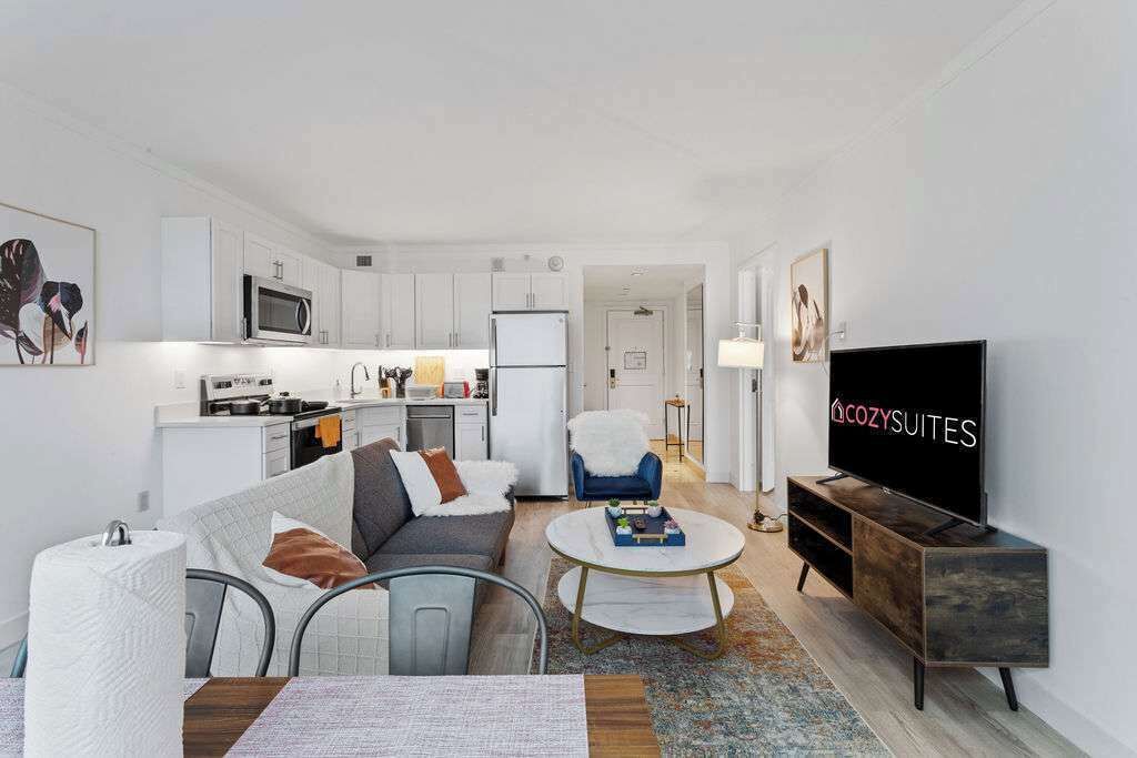 A modern living room with a sofa, coffee table, and TV.