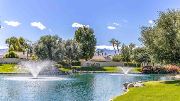 A landscaped area with a pond, fountains, and a well-maintained lawn. - Two King 👑 Suites,🌴Cozy Palm Desert Home Getaway ❤ 2 Great for Extended Stays! (Palm Desert)