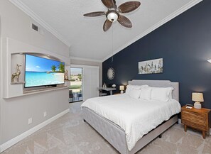A bedroom with a bed, a ceiling fan, a TV, and a view of the outdoors. - Two King 👑 Suites,🌴Cozy Palm Desert Home Getaway ❤ 2 Great for Extended Stays! (Palm Desert)