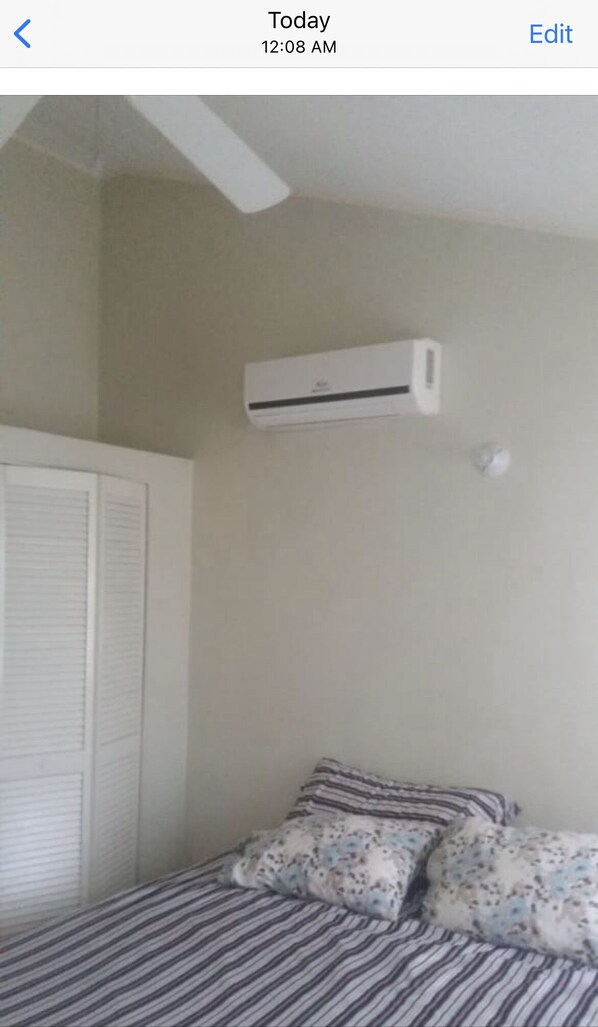 Enjoy a restful night's sleep in this cozy bedroom with a single bed and air conditioning for a comfortable stay.