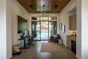 A modern home interior with a kitchen, dining area, and living space.